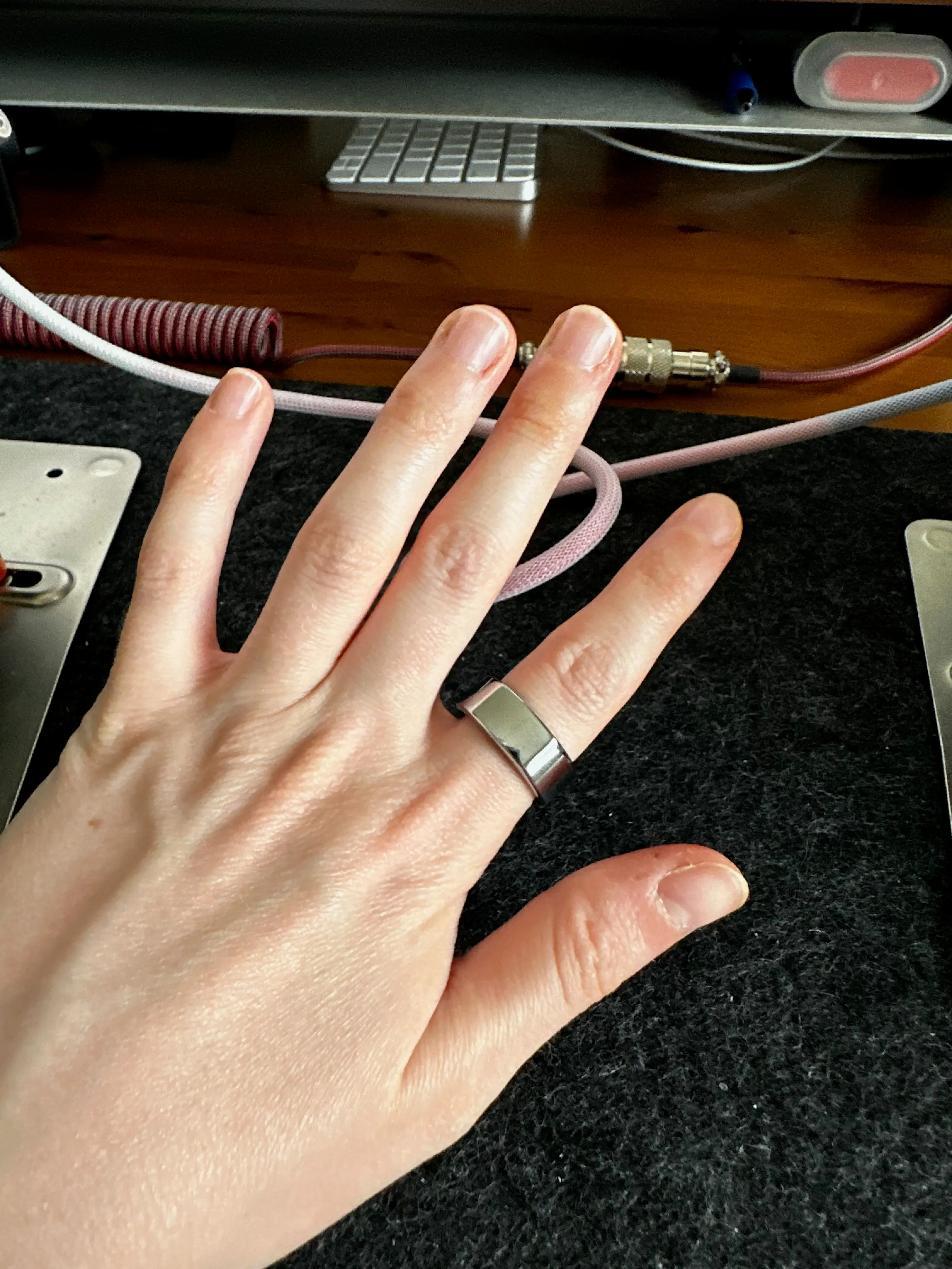 A tiny pale hand with a big silver Oura ring